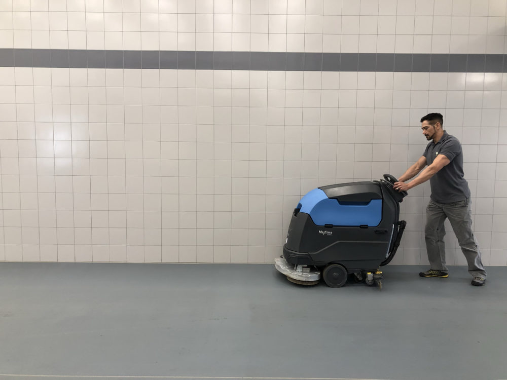 industrial cleaning services - man using scrubber dryer